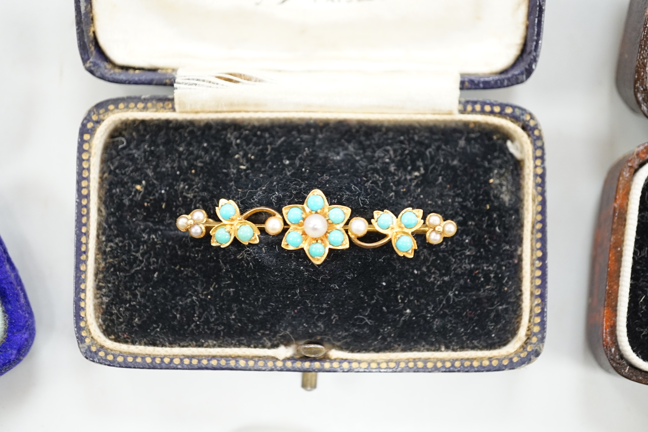 An Edwardian 15ct gold and seed peal set heart drop bar brooch, 40mm, gross weight 2.7 grams, two other yellow metal and gem set bar brooches and a Victorian citrine set brooch.